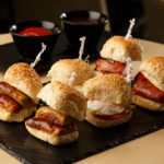 Bacon and sausage breakfast sliders on a slate, as part of mercure hotels meeting food offering