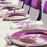 Purple place settings at the head table of a wedding