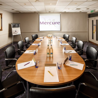 Table and chairs ready for a meeting in the Ambassador Room