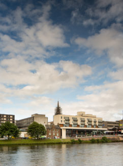 Exterior shot of the front of the mercure inverness hotel with the River Ness in the foreground