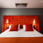 Wide shot of an orange headboard in a newly refurbished bedroom at mercure inverness hotel