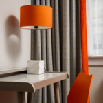 Close up of desk, orange chair and lamp in privilege room at mercure inverness hotel