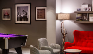 Pool table and red sofa in the lounge area of mercure inverness hotel